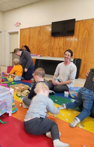 Our newly formed playgroup, kids and adults playing at the white buildings